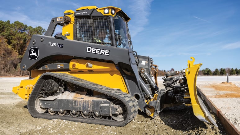 325G Compact Track Loader next to a jobsite