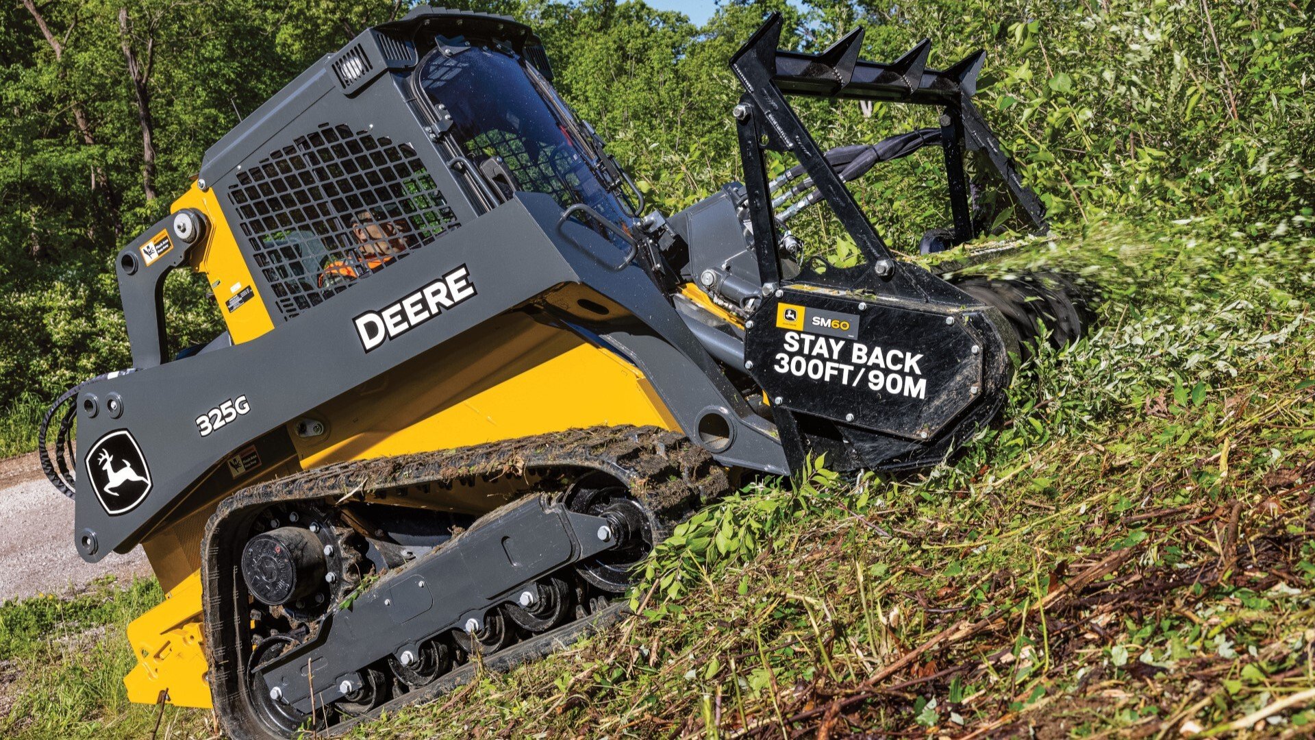 325G clearing large brush with specialized attachment