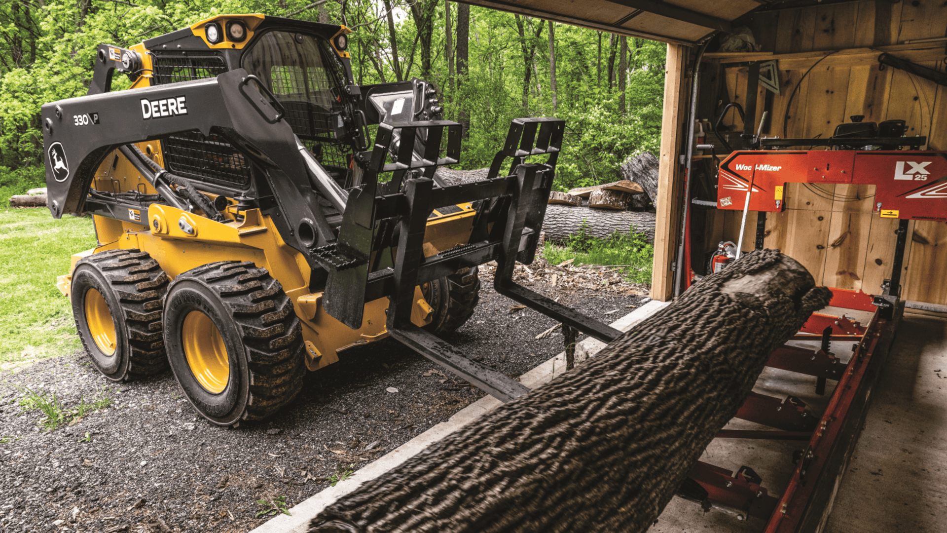 330 p skid steer lifting a log