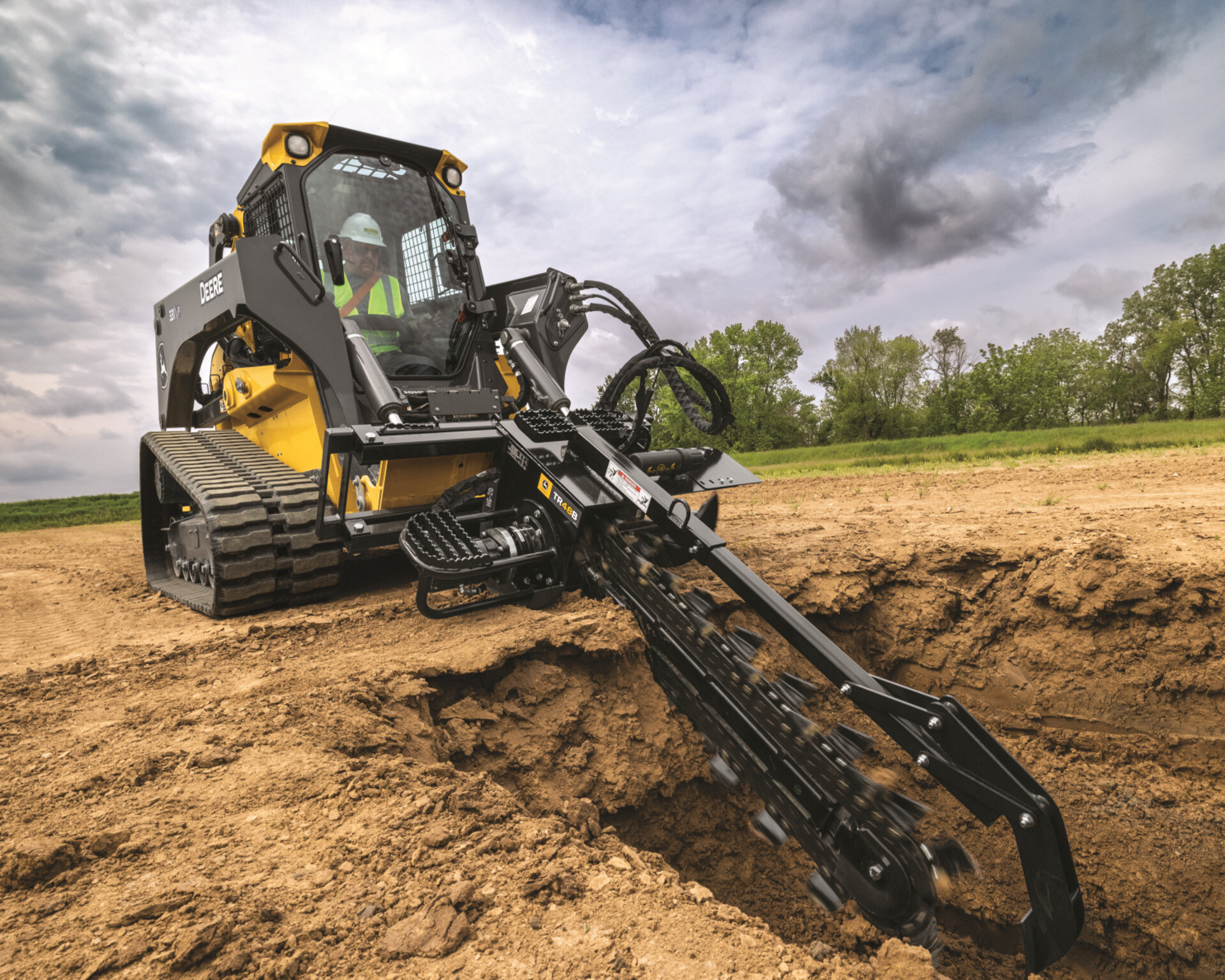 A 331 P-Tier compact track loader from John Deere with a digging attachment.