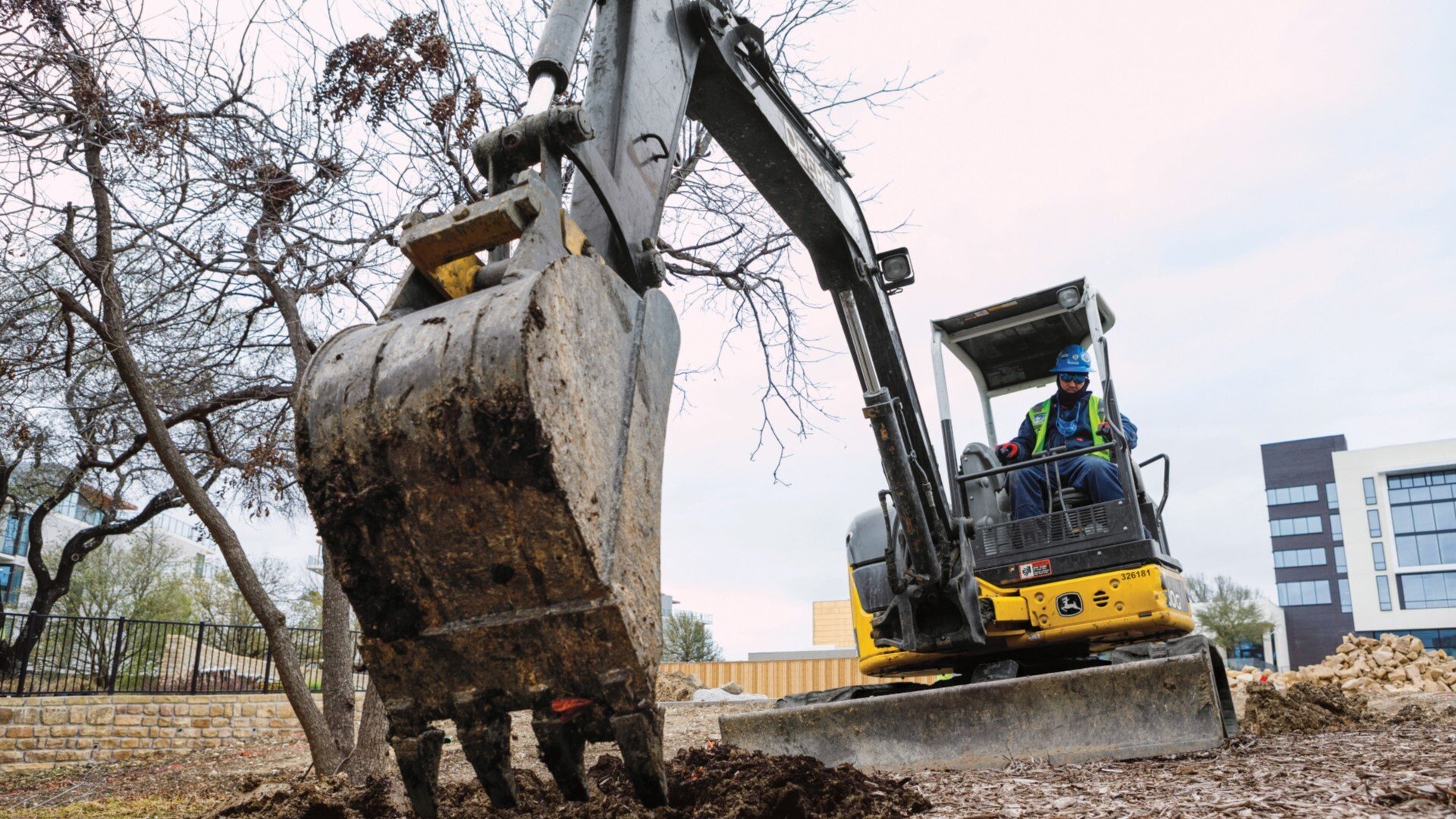 50G Compact Excavator being used to landscape and move mulch