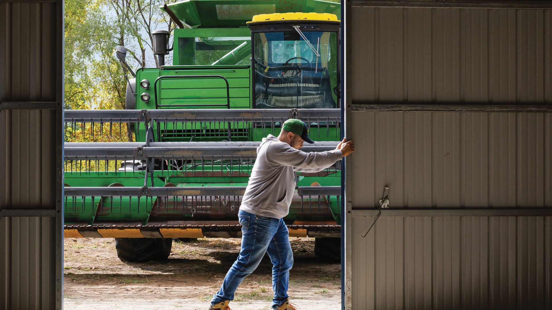 Farmer preparing to put his combine in store for the winter