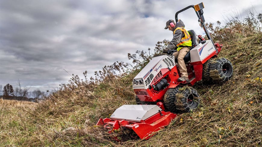 Ventrac mowing thick brush on steep slope