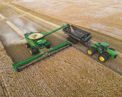 A John Deere X91000 Combine in a field harvesting grain.