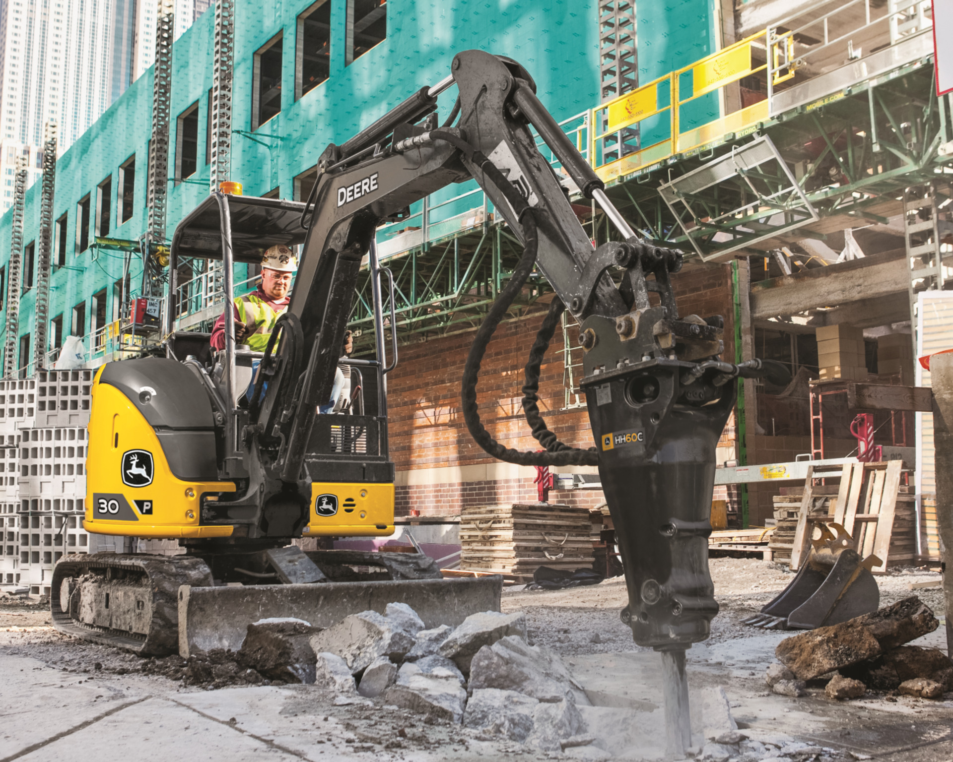 A John Deere 30P with a drilling attachment.