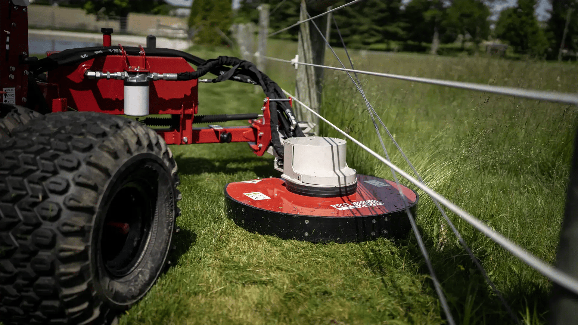 Ventrac Post Mower deck swinging around a fence post.