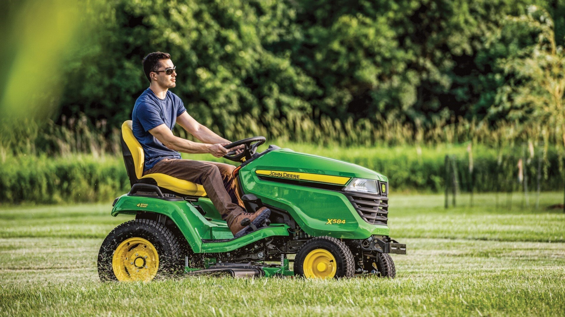 X584 Lawn tractor with 54 in deck being used to mow a lawn