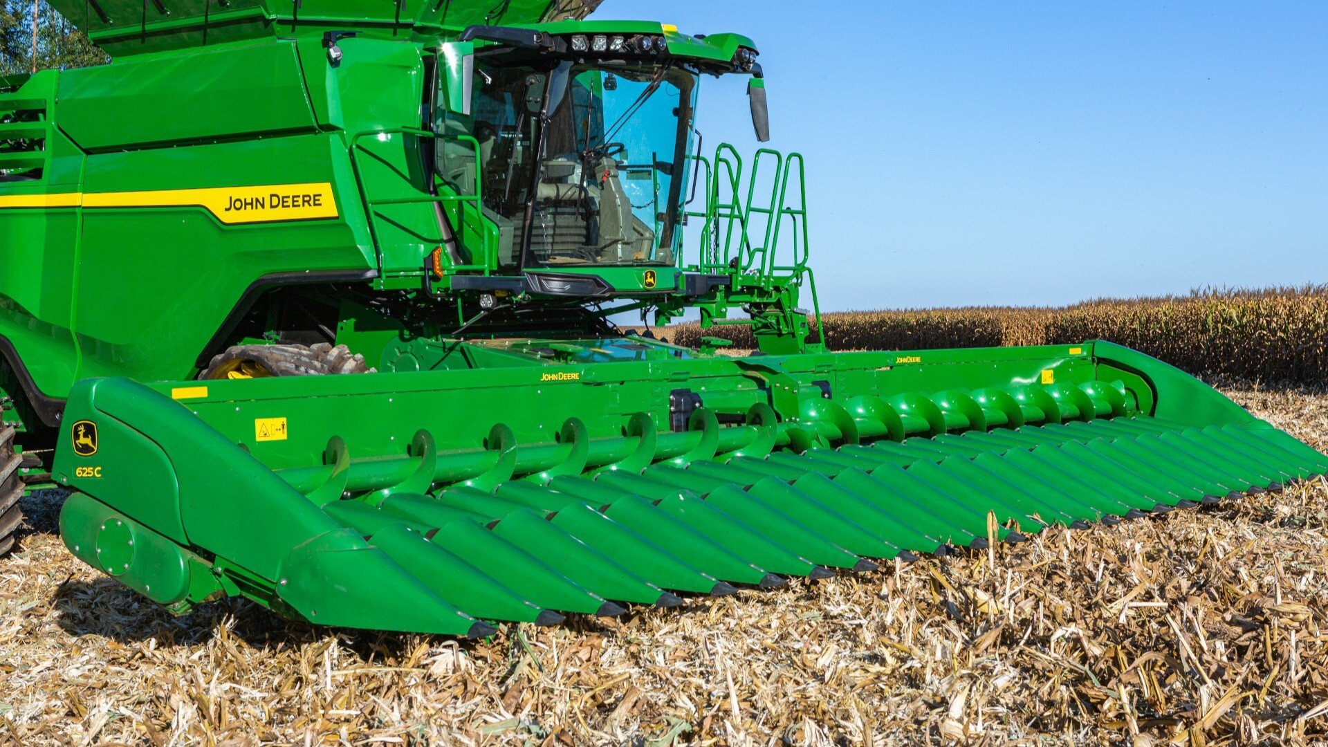 X9 1000 John Deere Combine with corn head in the field before a harvest