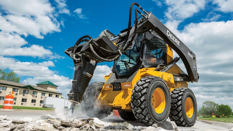 Skid Steer being used to break up concrete