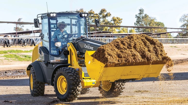 Compact Loader hauling dirt